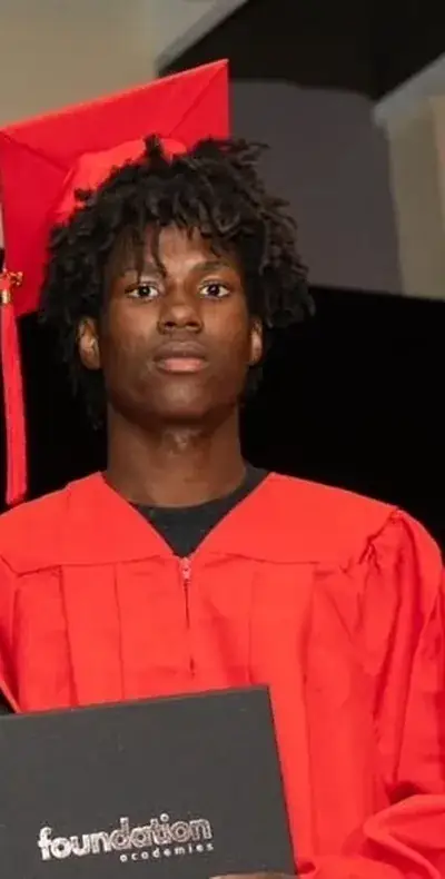 Graduate holding his diploma