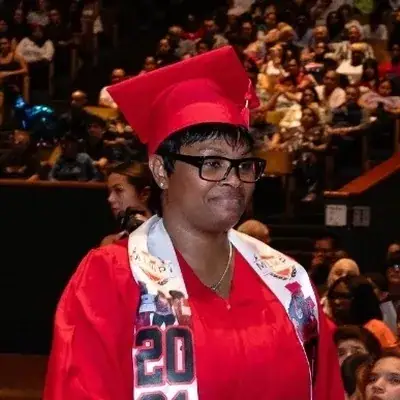 Graduate in cap and gown at commencement